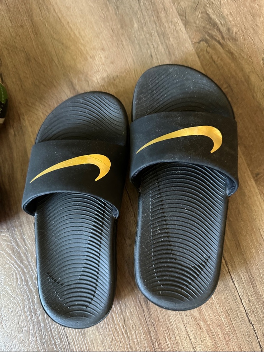 Nike Black Slide Sandals with Gold Swoosh Accent